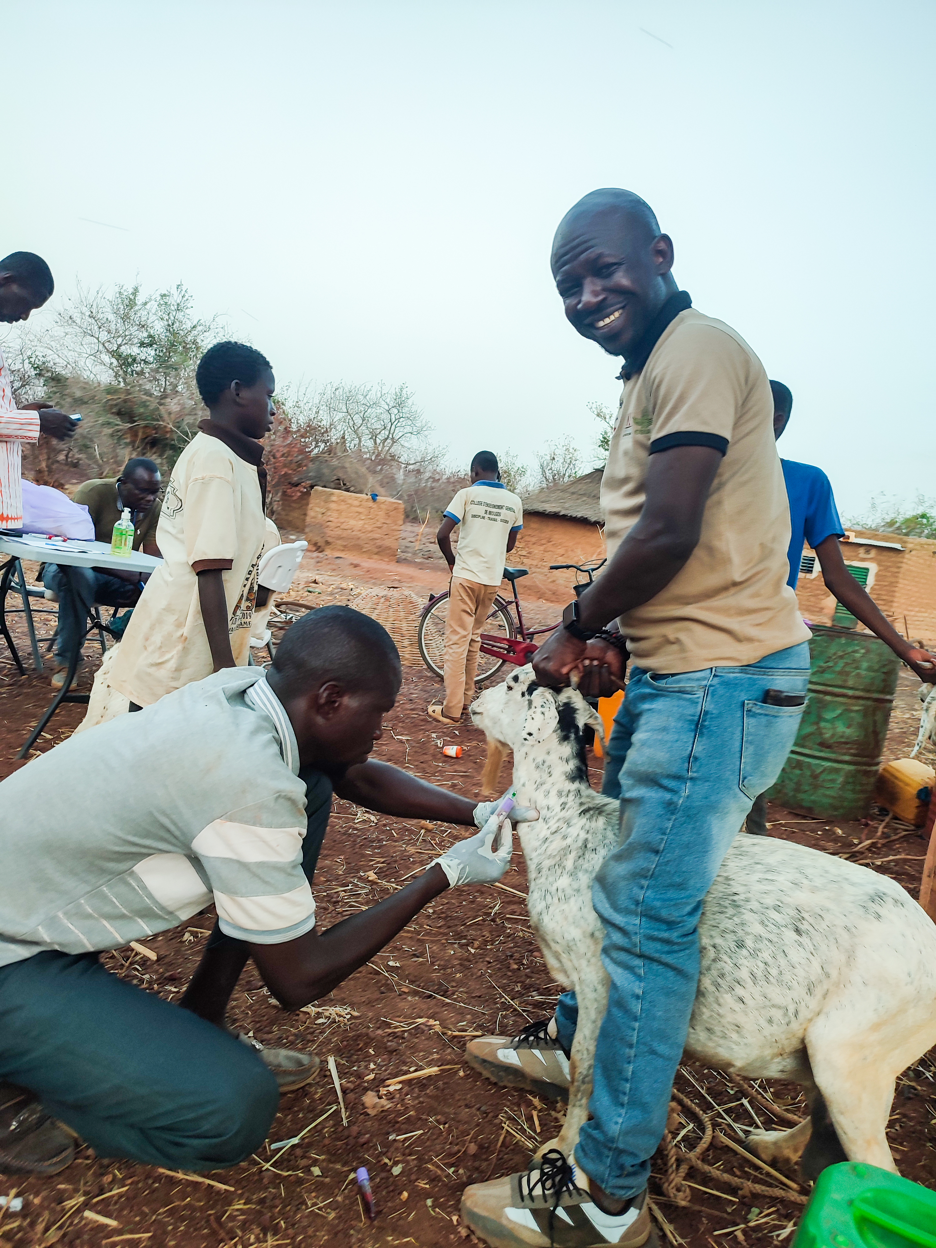 Abdoul on the right helping a field worker take a blood sample