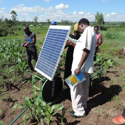 Farmer shows Feed the Future Kenya AVCD team her solar power in Opapo orange-flesh sweet potato site visit in Migori county. (photo credit: ILRI /Muthoni Njiru) 