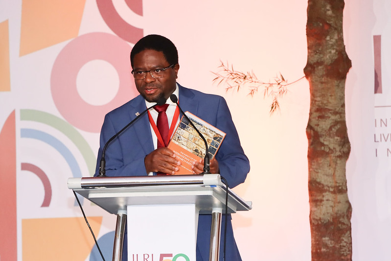 Appolinaire Djikeng, Director General, ILRI showcasing ILRI's impact book at the ILRI at 50 celebrations (photo credit: ILRI/ Geoffrey Njenga).