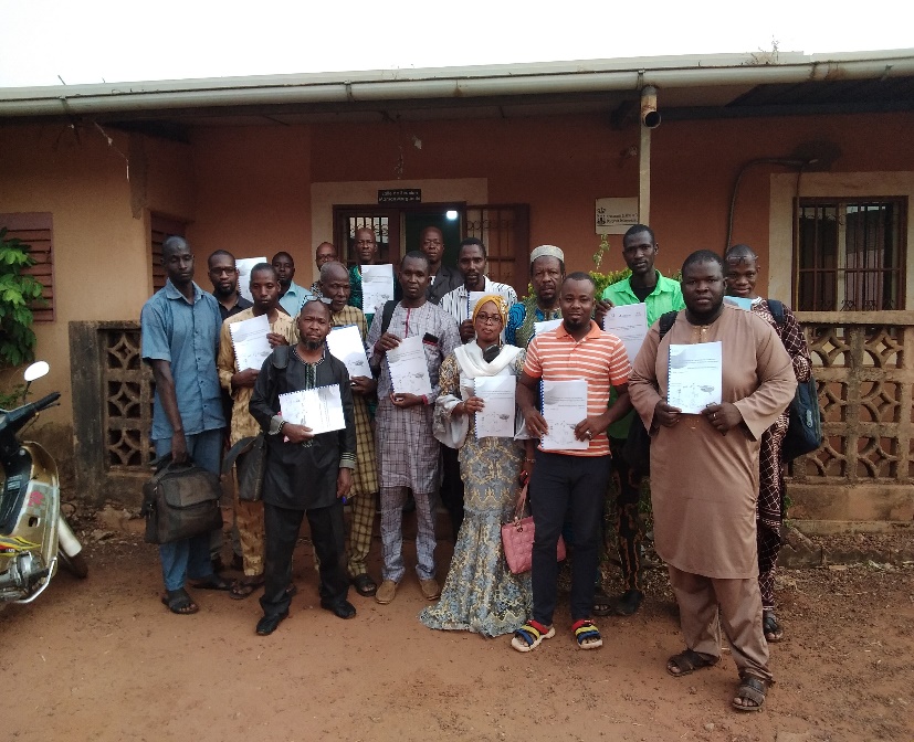 A group of people holding papers</p>
<p>Description automatically generated