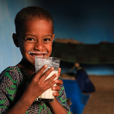 Senait Abate drinking milk produced by the family cow (photo credit: ILRI/Apollo Habtamu).