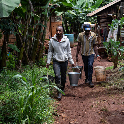 Young men carrying milk