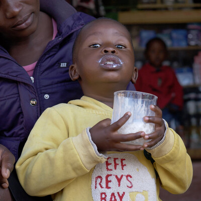A boy drinking milk outside of a milk shop in Nairobi, Kenya. Photo ILRI/Shadrack Isingoma A boy drinking milk outside of a milk shop in Nairobi, Kenya. Photo ILRI/Shadrack Isingoma