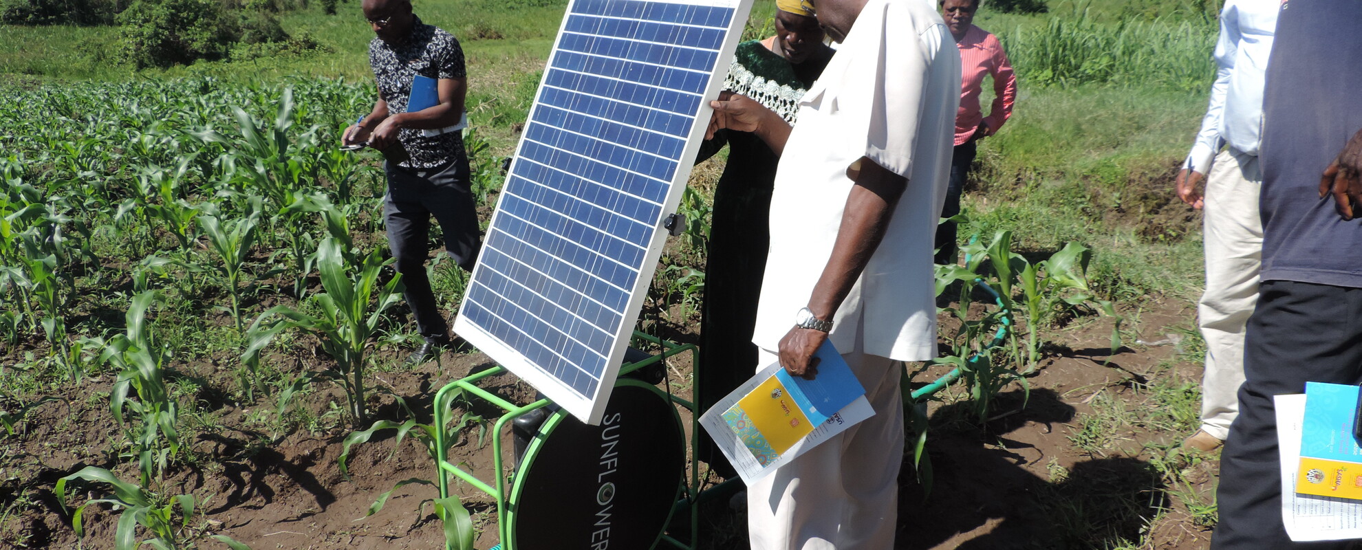 Farmer shows Feed the Future Kenya AVCD team her solar power in Opapo orange-flesh sweet potato site visit in Migori county. (photo credit: ILRI /Muthoni Njiru) 