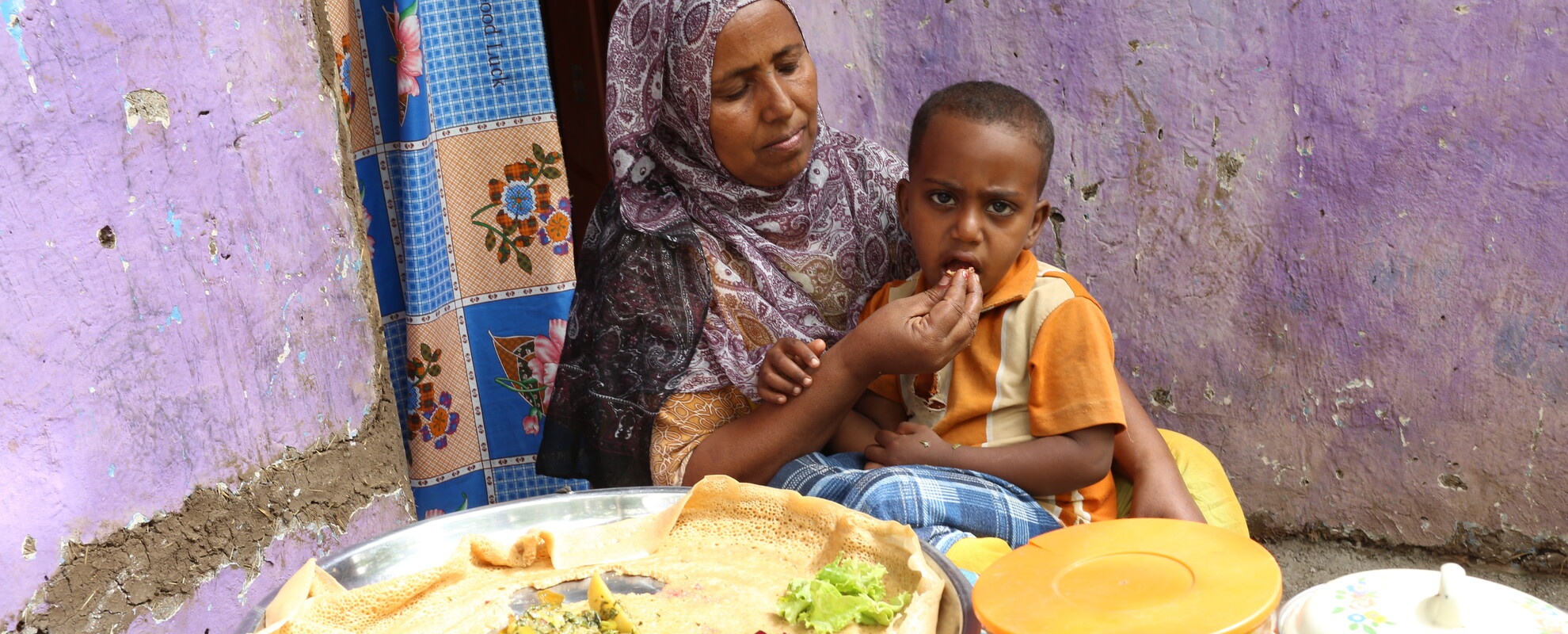 Zenebech Abdu feeding her child a balanced diet (Photo Credit: ILRI\Apollo Habtamu).