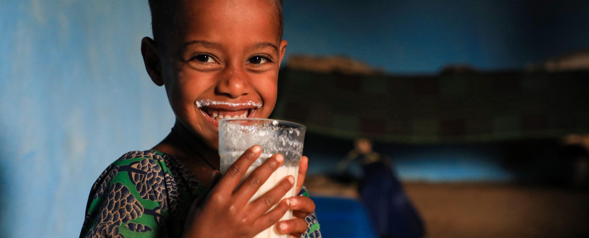 Senait Abate drinking milk produced by the family cow (photo credit: ILRI/Apollo Habtamu).