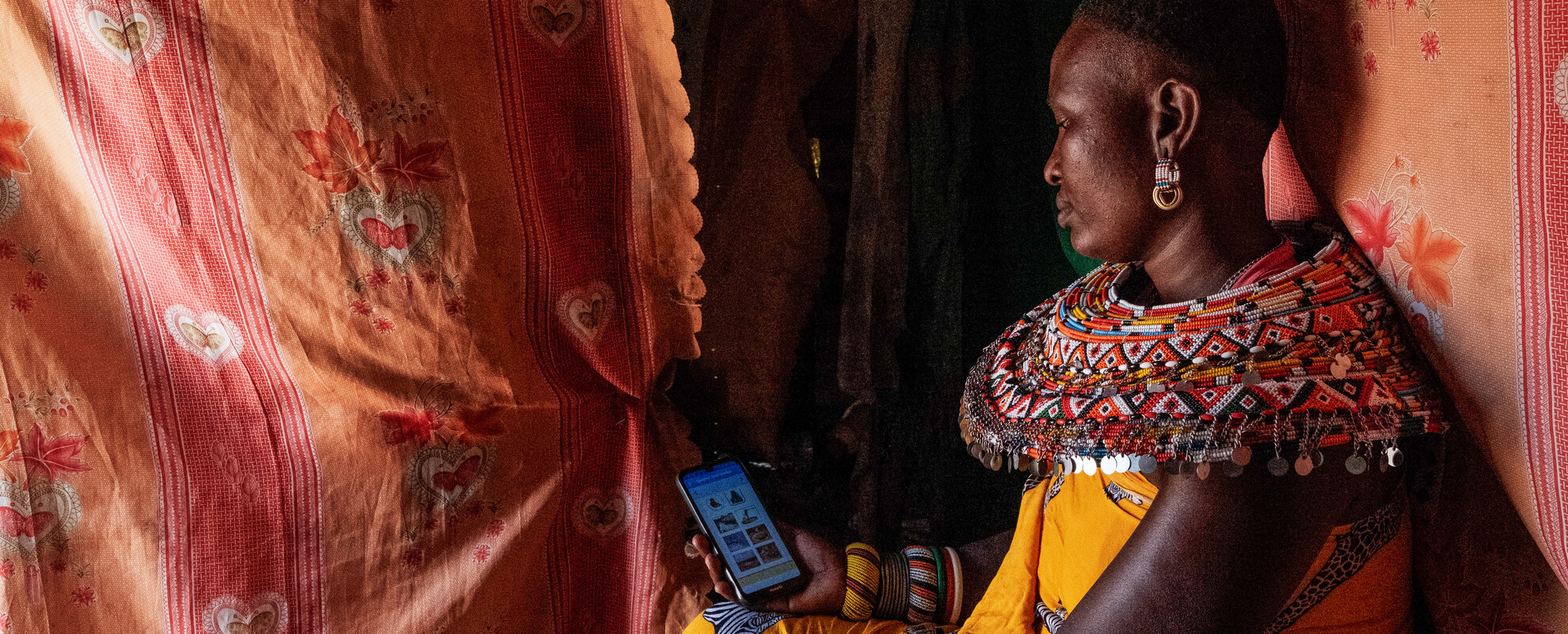 A Samburu mother enters nutrition data into an app (photo caption: ILRI/Kabir Dhanji).