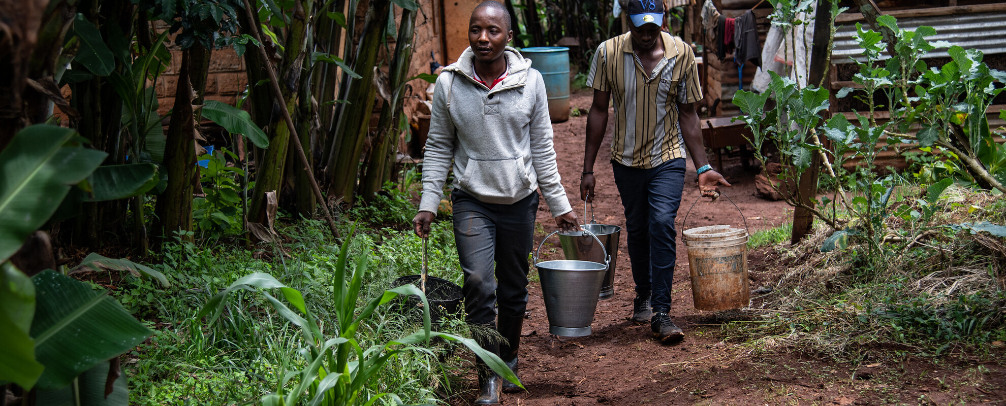 Young men carrying milk